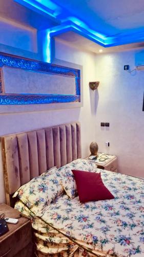 a bedroom with a bed with a blue ceiling at Farm near Marrakech , Location ferme Marrakech in Marrakesh