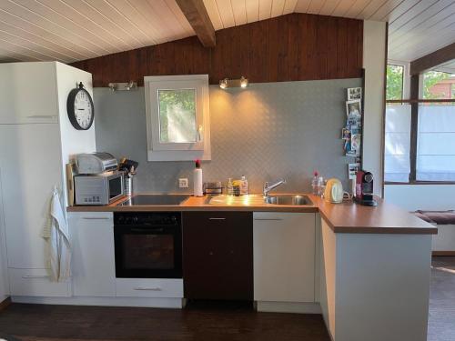 a kitchen with a sink and a counter top at Le Chalet in Font
