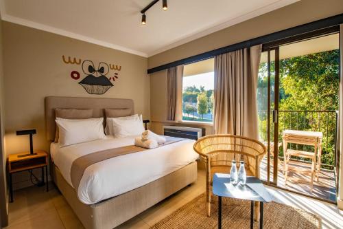 a bedroom with a bed and a balcony at BlackBrick Bedfordview ApartHotel in Johannesburg