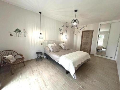 a bedroom with a bed and a chair in it at Quilleret in Haut-Mauco