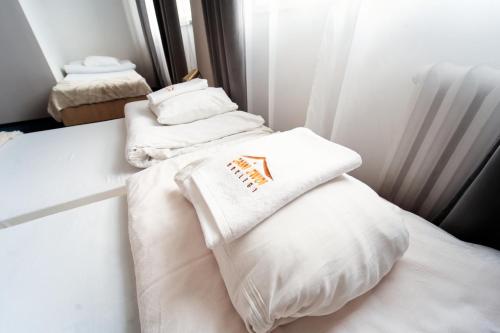 a room with three white pillows on a bed at Sami Swoi Kutno in Kutno