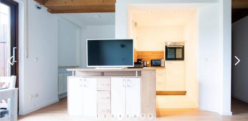 a living room with a tv on top of a cabinet at Haus Sonneneck in Schwangau