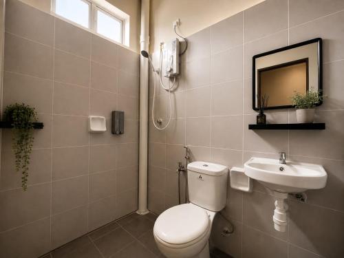 a bathroom with a toilet and a sink at iHomie Suites - 4Bedroom Homestay Kulim in Kulim