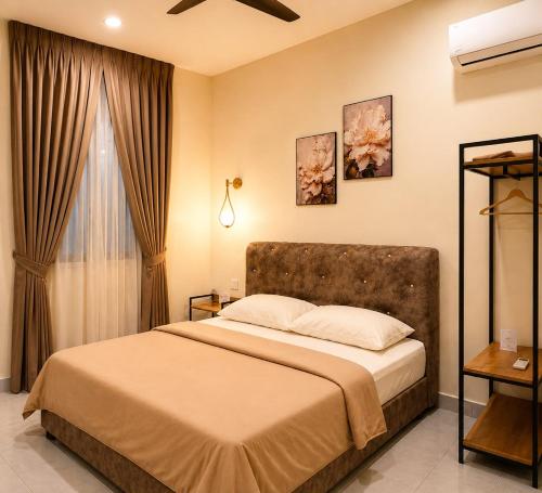 a bedroom with a large bed and a window at iHomie Suites - 4Bedroom Homestay Kulim in Kulim