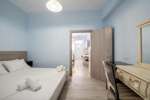 a bedroom with a large bed and a bathroom at Studio Beleri in Himare