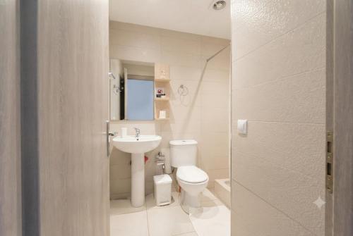 a small bathroom with a toilet and a sink at Studio Beleri in Himare