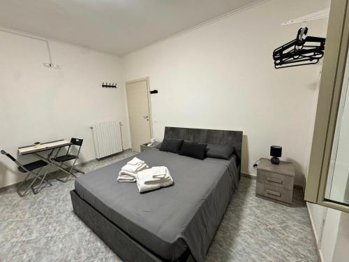 a bedroom with a bed with towels on it at Eden Affittacamere in Anzio