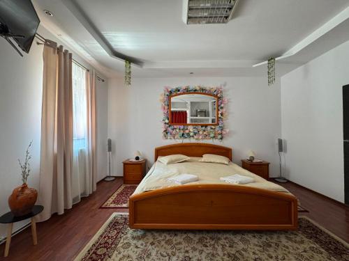 a bedroom with a bed and a mirror on the wall at Casa Lucescu in Vatra Dornei