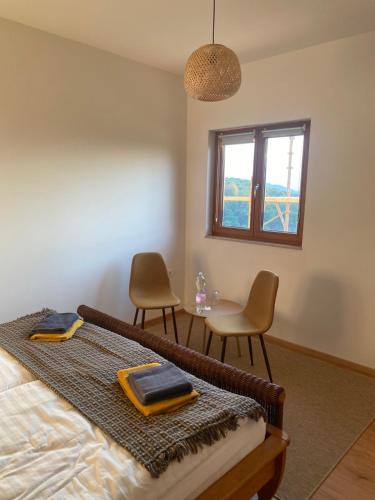a bedroom with a bed and a table and chairs at Villa Kasimir in Videm pri Ptuju