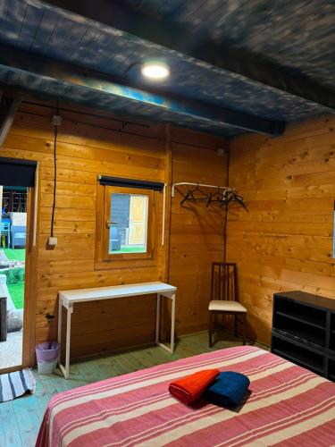 a bedroom with a bed in a wooden room at Surf Camp Ecológico in Costa da Caparica