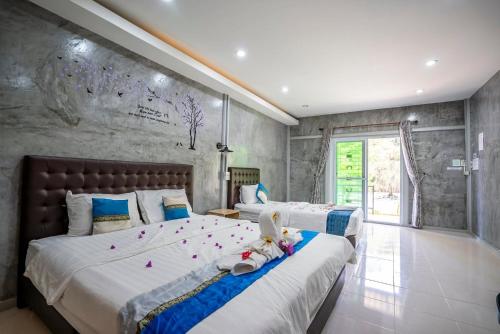 a bedroom with two beds with stuffed animals on them at Phangpring Beach Resort in Ban Phang Pling