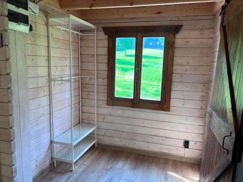 a sauna with a window in a wooden room at Relax nad Narwią u Oli Pawła in Chmielewo