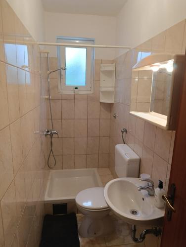 a bathroom with a sink and a toilet and a tub at Rooms with a parking space Krk - 5371 in Krk