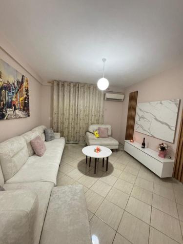 a living room with a couch and a table at Kodra Apartament in Golem
