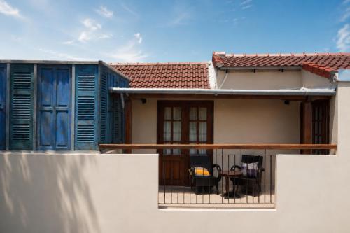 a house with blue shutters and a balcony at Sola Hoi An in Thanh Ðông (1)