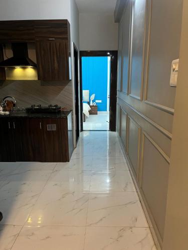 a kitchen with a tile floor and a view of the ocean at Couple friendly spacious 1BHK in Indore