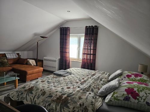 a bedroom with a bed and a couch at Aluston in Hannover