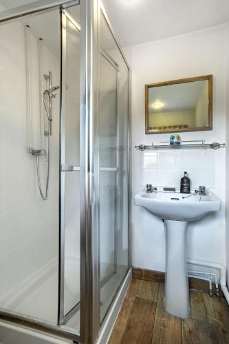a bathroom with a sink and a shower at Finest Retreats - The Little Barn in Great Somerford