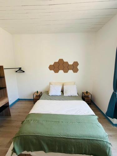 a bedroom with a large bed in a room at Appart cosy avec billard, à Bort in Bort-les-Orgues