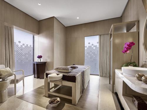a bathroom with a tub and a sink at Pullman Bandung Grand Central in Bandung