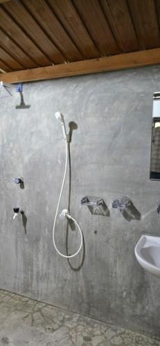 a painting of a shower on a wall next to a sink at Eco Palms in Pottuvil