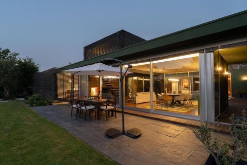 a patio with a table and an umbrella at Stars View by Portugal Active in Fafe