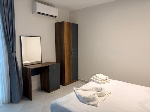a bedroom with a bed and a vanity with a mirror at Bohemia palace in Hurghada