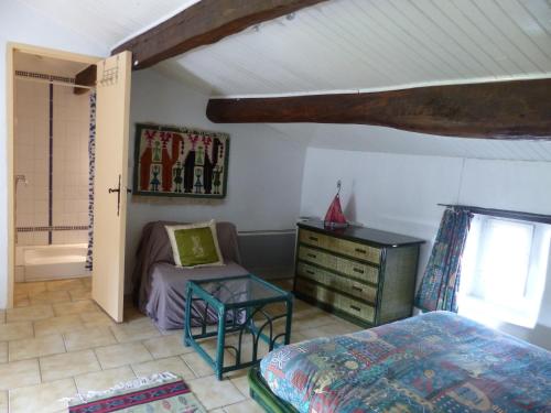 a bedroom with a bed and a desk and a chair at Brimborion in Alba-la-Romaine