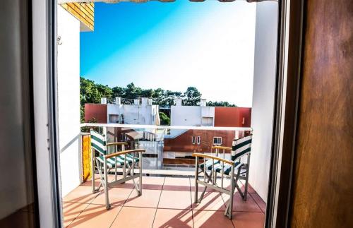 a view of a balcony with chairs and a table at Ocean view Cabedelo Beach Duplex in Viana do Castelo