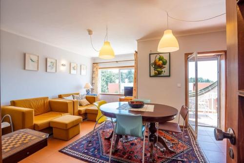 a living room with a table and a couch at Ocean view Cabedelo Beach Duplex in Viana do Castelo
