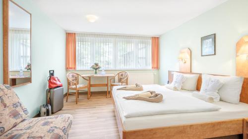 a hotel room with a bed and a table at Hotel Thüringenschanze in Oberhof