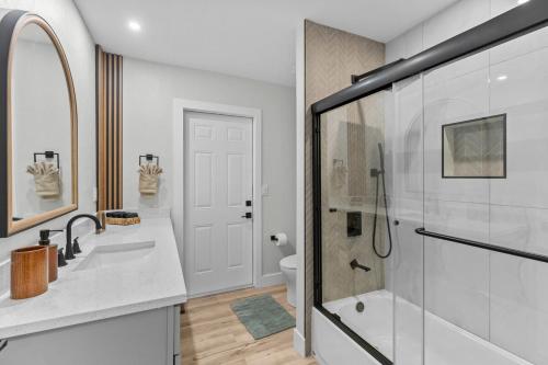 a bathroom with a shower and a sink and a toilet at Waterfront Pool Game Room Gulf Access in Cape Coral