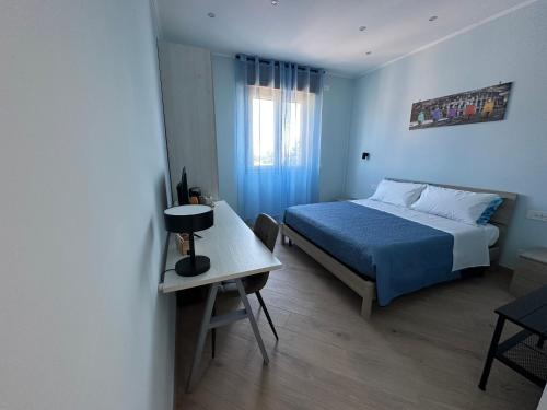a bedroom with a bed and a table in it at B&B Gino&Giulia in Aprilia