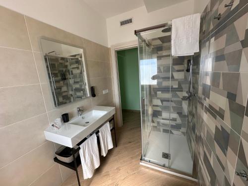 a bathroom with a sink and a shower at B&B Gino&Giulia in Aprilia