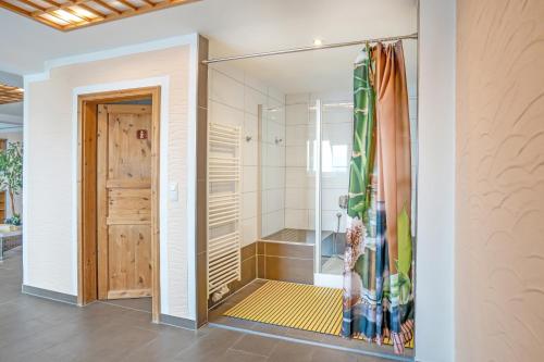 a shower with a glass door in a bathroom at Hotel Thüringenschanze in Oberhof