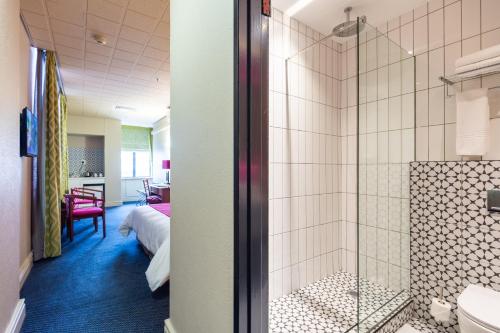 a bathroom with a shower and a bedroom at Cape Town Lodge Hotel in Cape Town