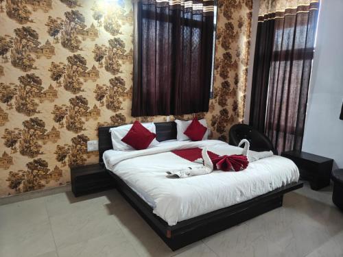 a bedroom with a bed with a dog laying on it at Hotel Shaktideep in Pushkar