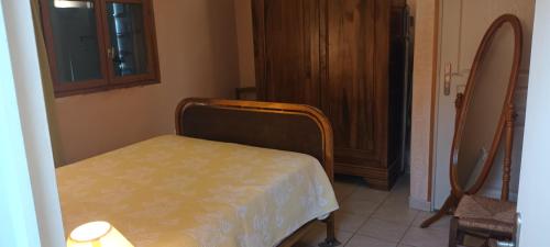 a bedroom with a bed in a room with a door at Le chèvrefeuille in Sahune