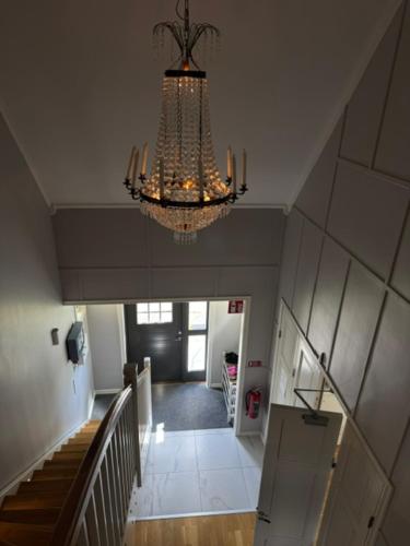 a chandelier hanging from the ceiling in a hallway at Lindens Bed&Breakfast in Mellerud