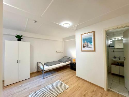 a bedroom with a bed and a cabinet in a room at Garten-Apartment in Selm