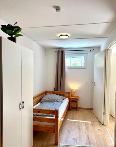 a bedroom with a bed and a window at Garten-Apartment in Selm