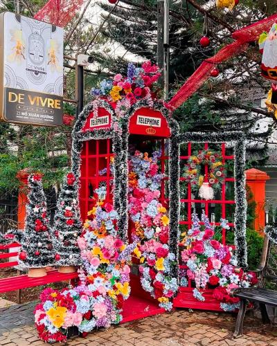 a display of flowers in a red booth at De Vivre Café & Home in Kon Plong