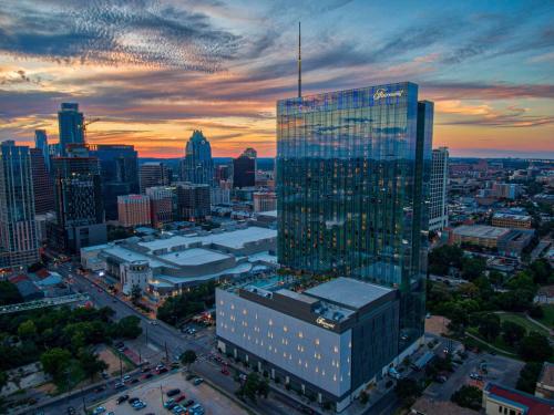 a tall glass building in a city at sunset at Fairmont Austin in Austin