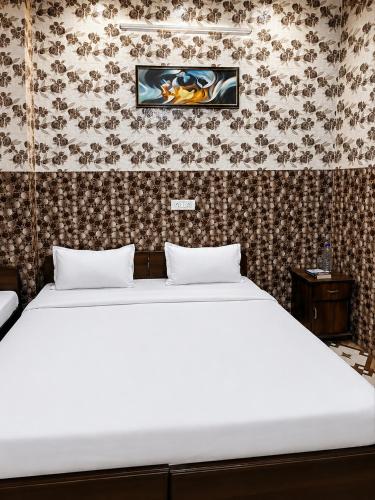 a bed with two pillows in a room at crown house in Phagwāra