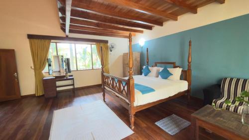 a bedroom with a canopy bed and a window at Thambapanni Villa in Unawatuna