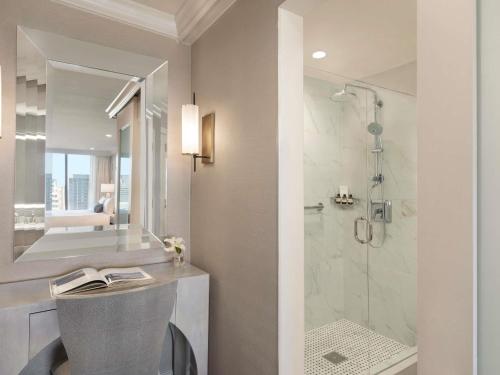 a bathroom with a sink and a shower at Fairmont Dallas in Dallas