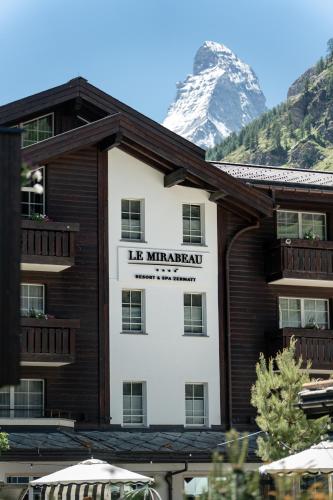 a hotel with a mountain in the background at Mirabeau Alpine in Zermatt
