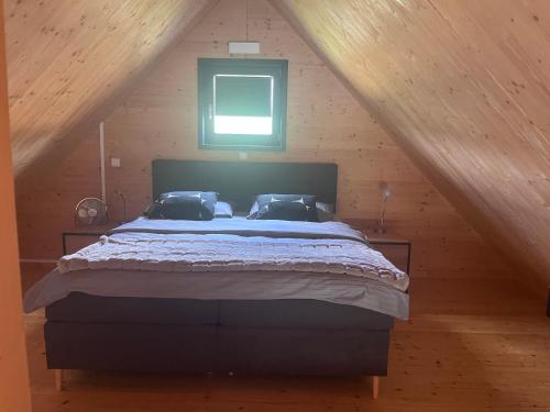 a bedroom with a large bed in a attic at Ferienhaus an der Wasserkuppe in Poppenhausen