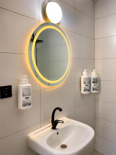 a bathroom with a sink and a mirror at Blue Sea Hotel in Tuzla