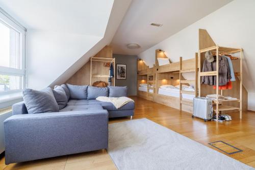 a living room with a couch and bunk beds at Luci House Boutique Hostel - Vienna 15th district in Vienna
